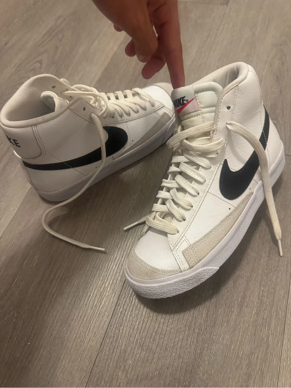 Nike Women's White High-Top Sneakers with Black Swoosh